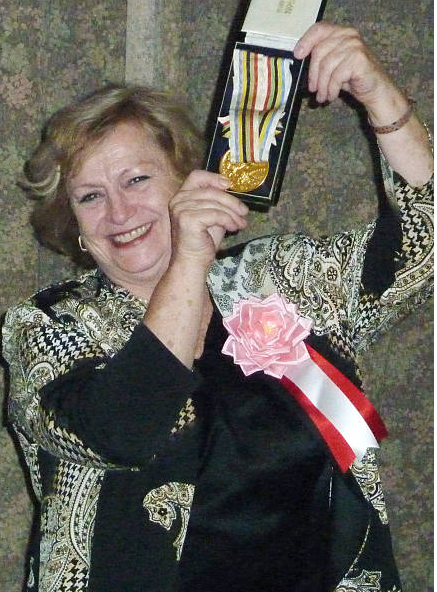 Věra Čáslavská holding gold medal she won in the 1964 Oympics