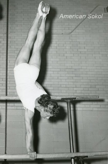 woman competing on the uneven bars
